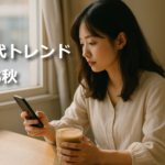 カフェの窓際でスマホを見るZ世代の女性、共感とやさしさの時代を象徴